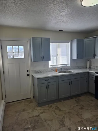 a kitchen with a refrigerator and a sink
