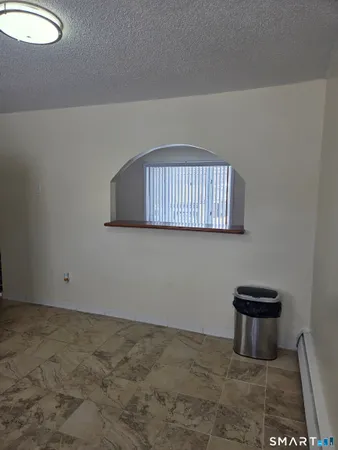 a bathroom with a sink toilet and window