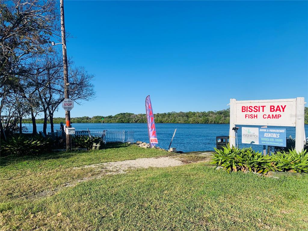 251 Bissit Bay Road Oak Hill, FL 32759 - Photo 2 of 9 a view of a sign board with a yard