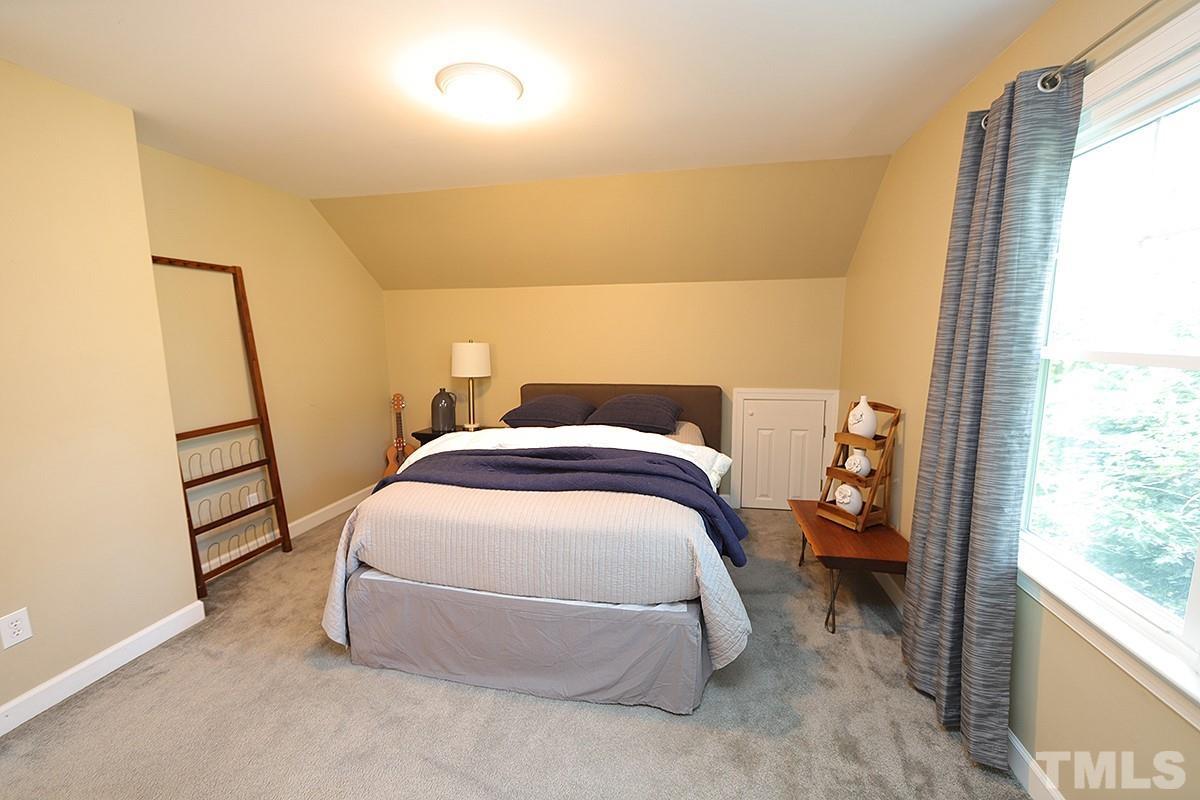 3715 Bellevue Road Raleigh, NC 27609 - Photo 11 of 15 a bed sitting in a bedroom next to a window