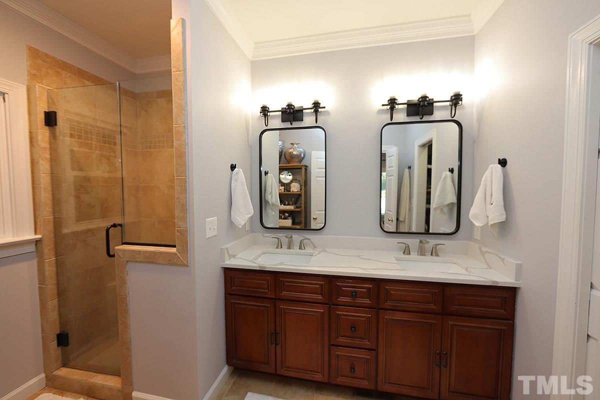 3715 Bellevue Road Raleigh, NC 27609 - Photo 3 of 15 a bathroom with a double vanity sink and a mirror
