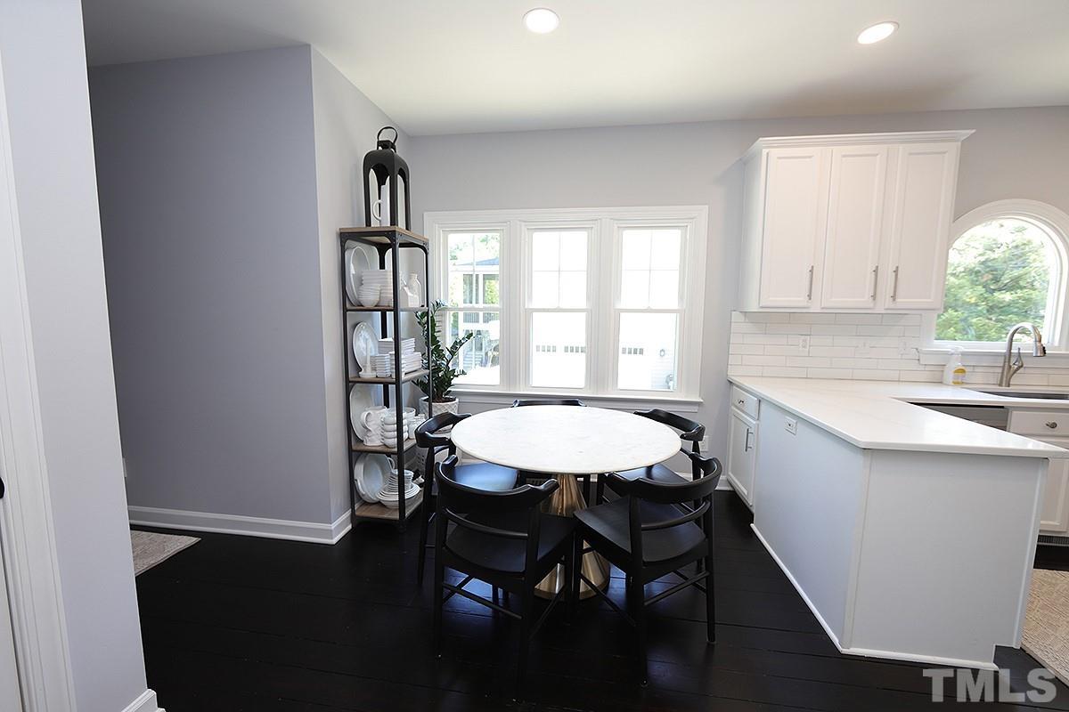 3715 Bellevue Road Raleigh, NC 27609 - Photo 6 of 15 a kitchen with a table chairs sink and cabinets