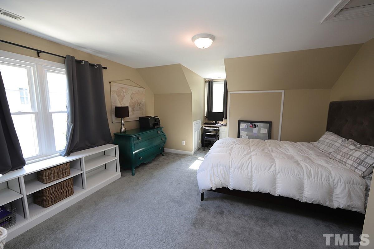 3715 Bellevue Road Raleigh, NC 27609 - Photo 10 of 15 a bedroom with a bed and a television