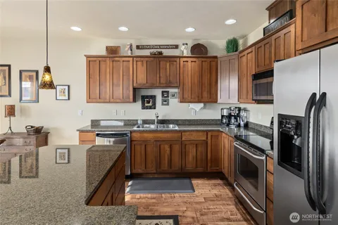 a kitchen with stainless steel appliances granite countertop a refrigerator sink and cabinets