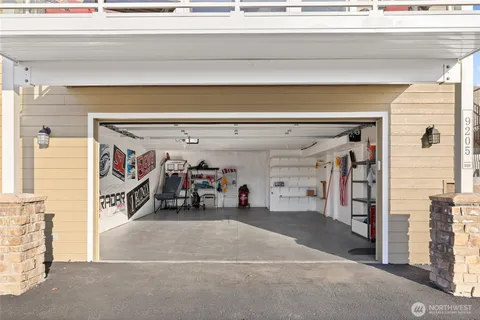 a view of a garage with a white car parked