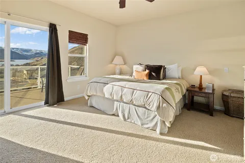a spacious bathroom with a tub sink and mirror