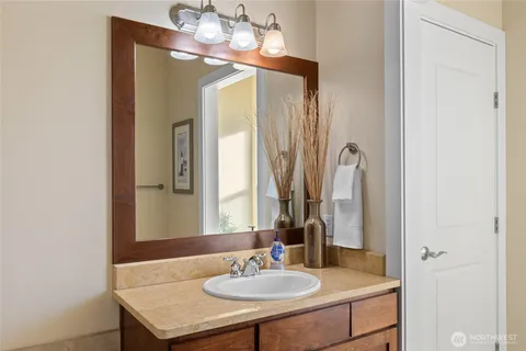 a bathroom with a sink a toilet and a mirror