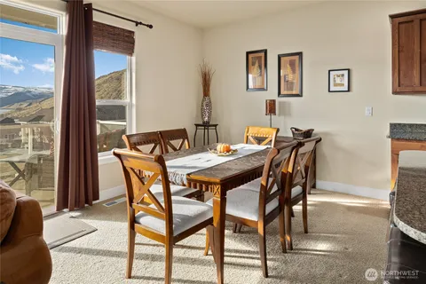 a view of a dining room with furniture and a floor to ceiling window