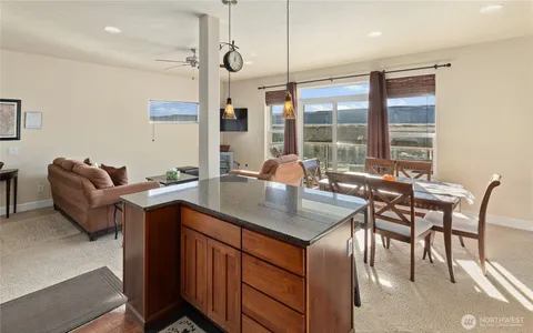 a kitchen with a table chairs sink and cabinets