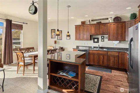 a kitchen with stainless steel appliances granite countertop a sink and cabinets