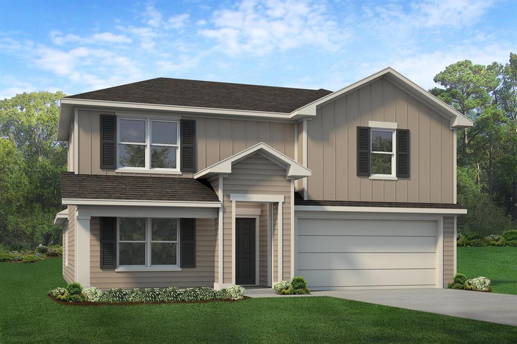 a front view of a house with a garden and yard