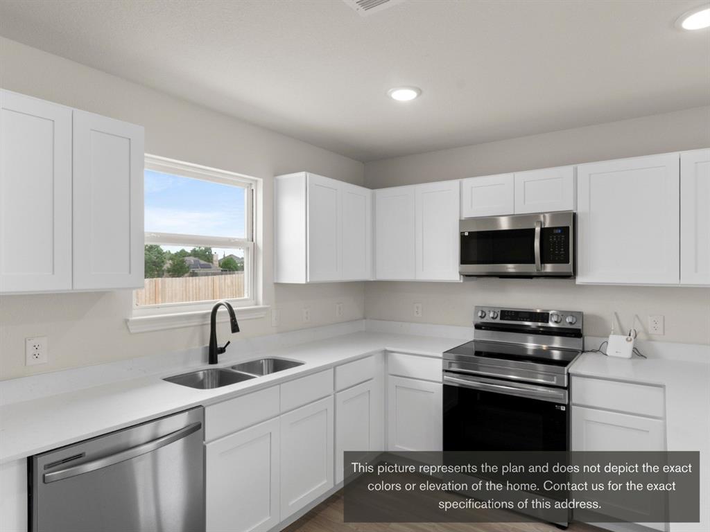 1809 Zelvia Lane Waco, TX 76708 - Photo 12 of 26 a kitchen with stainless steel appliances a sink dishwasher a stove and a microwave