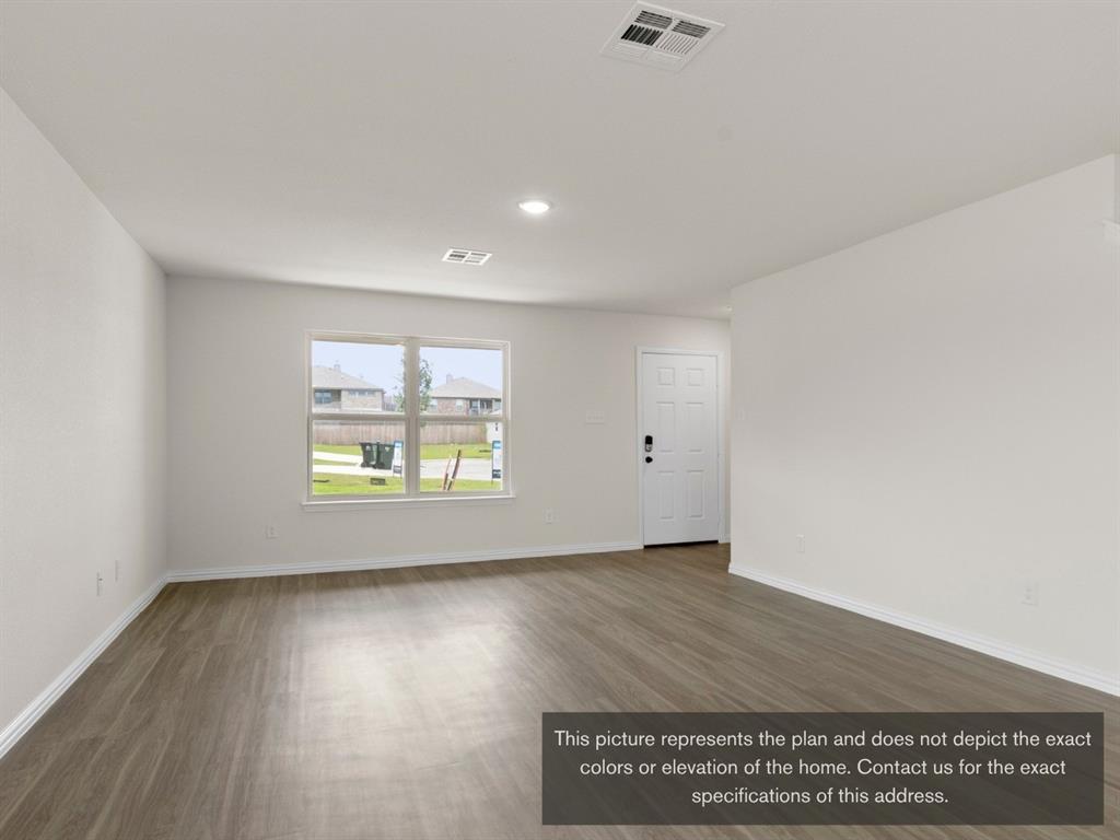 1809 Zelvia Lane Waco, TX 76708 - Photo 4 of 26 an empty room with wooden floor and windows