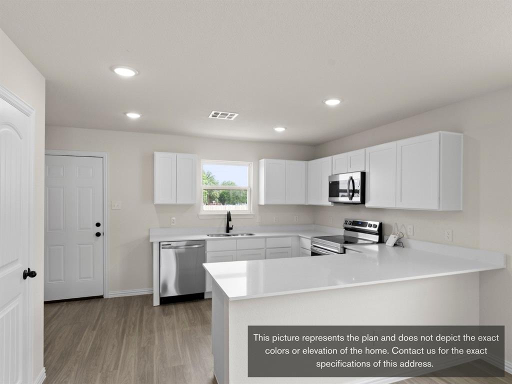 1809 Zelvia Lane Waco, TX 76708 - Photo 8 of 26 a kitchen with stainless steel appliances a sink a stove a refrigerator cabinets and a window