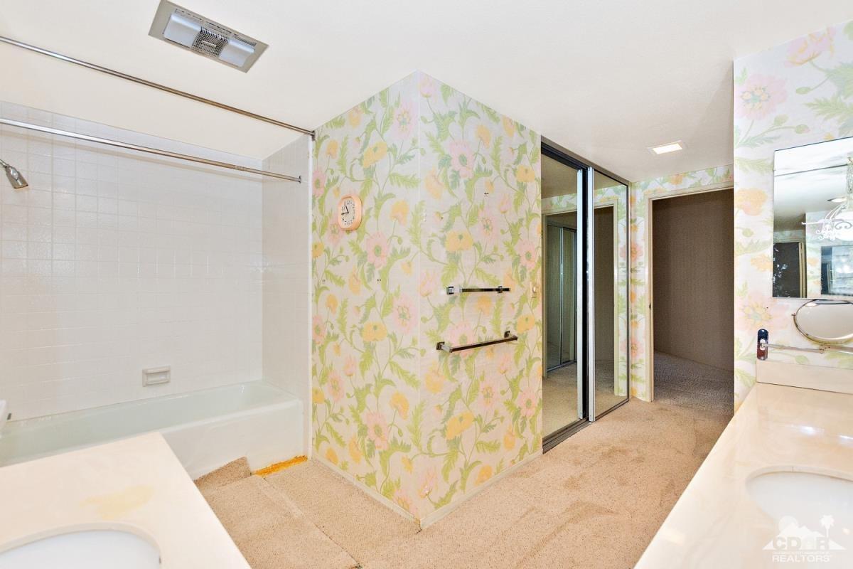 900 Island Drive, Unit 109 Rancho Mirage, CA 92270 - Photo 13 of 19 a bathroom with a bathtub and shower