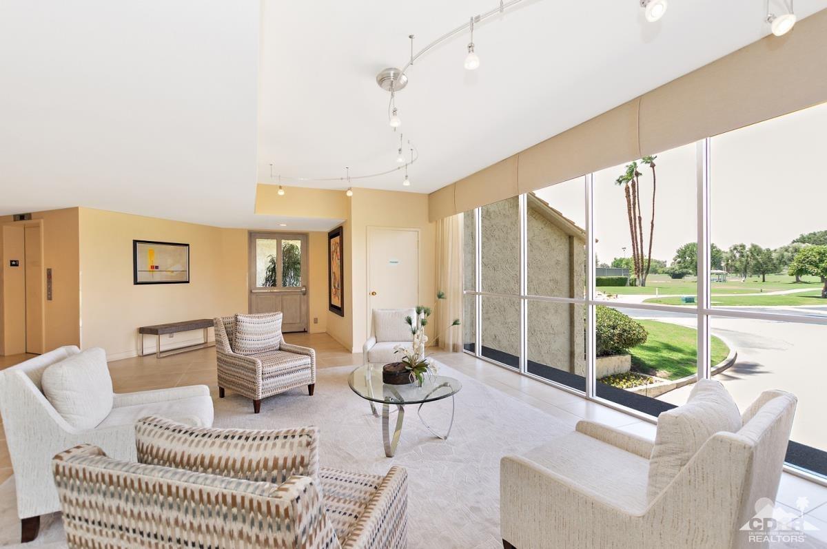 900 Island Drive, Unit 109 Rancho Mirage, CA 92270 - Photo 19 of 19 a living room with furniture and a large window