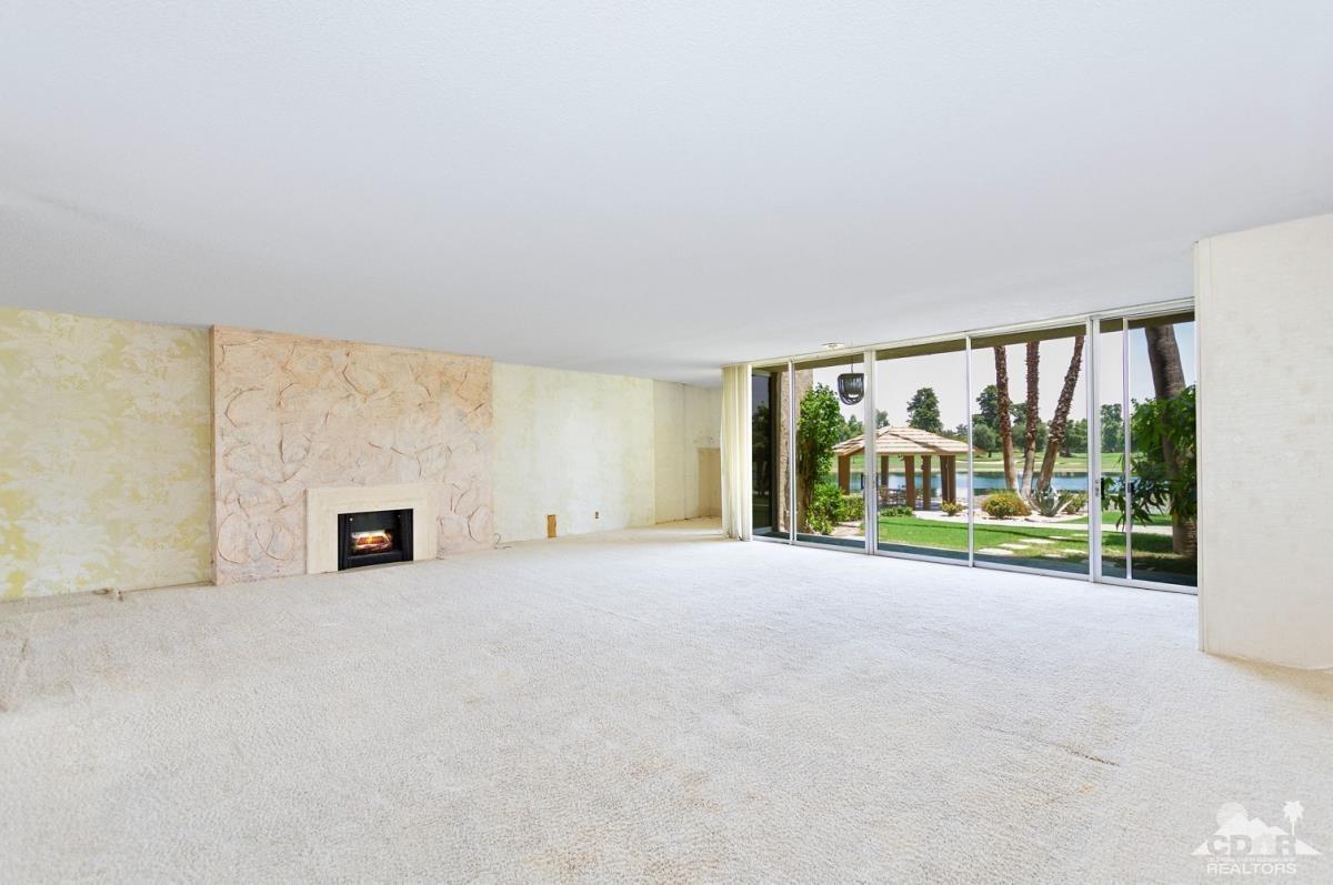 900 Island Drive, Unit 109 Rancho Mirage, CA 92270 - Photo 4 of 19 an empty room with floor to ceiling window and an outdoor view