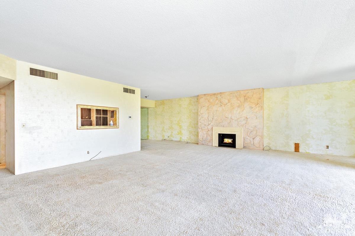 900 Island Drive, Unit 109 Rancho Mirage, CA 92270 - Photo 7 of 19 an empty room with windows