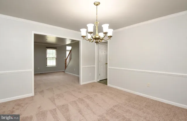 a view of a chandelier in big room and chandelier