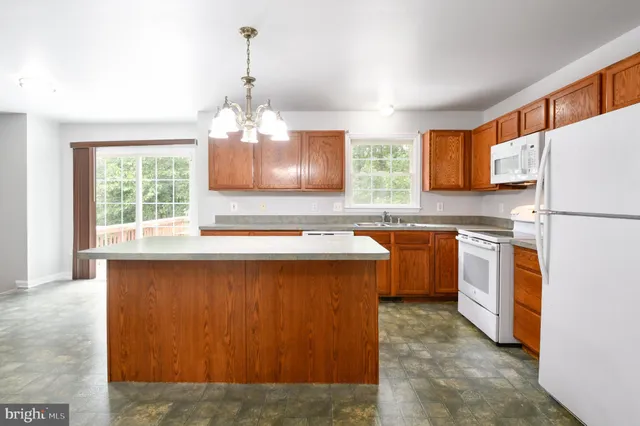 a kitchen with sink a refrigerator and a stove