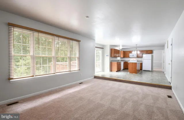 a big room with window and wooden floor
