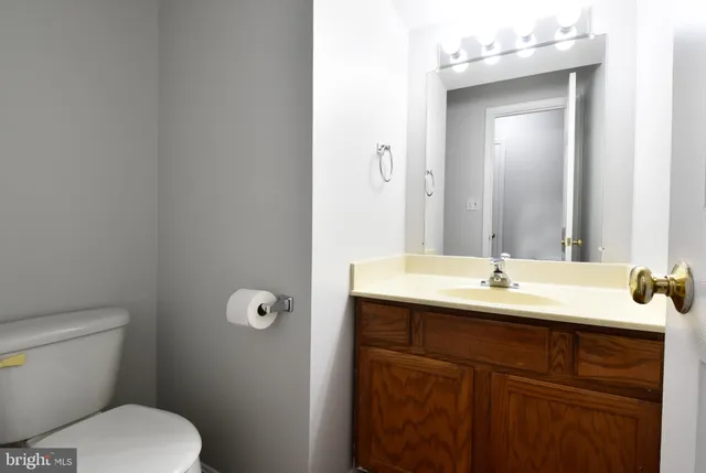a bathroom with a toilet sink and mirror