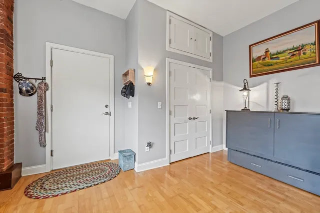 a bedroom with a bed and a painting on the wall