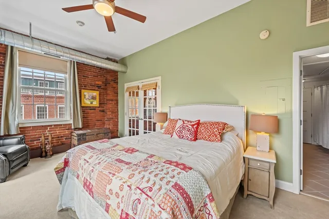 a bedroom with a large bed and a chandelier