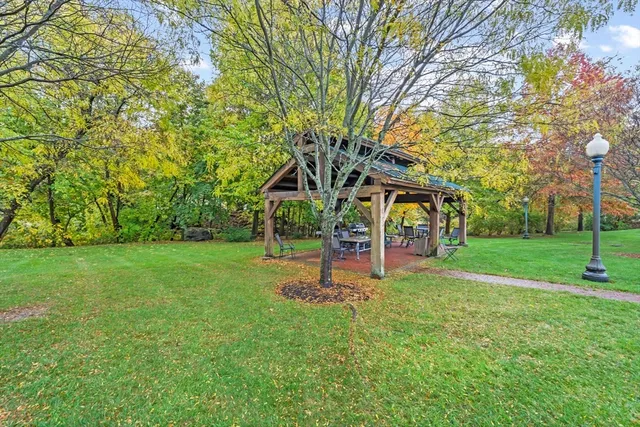 a view of a house with a big yard and large trees