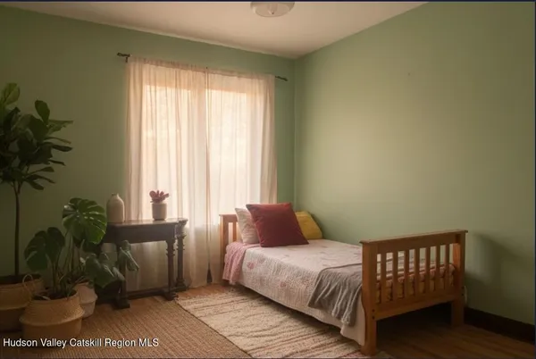 a large bed sitting in a bedroom next to a window and a potted plant