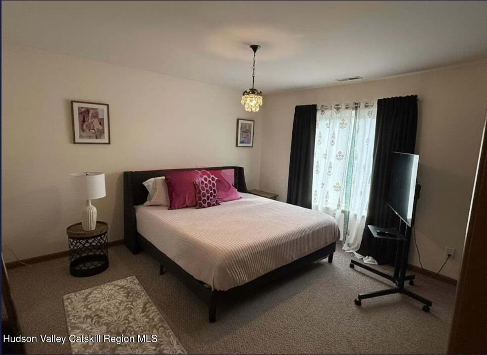 614 Salls Road New Lebanon, NY 12029 - Photo 14 of 22 a bedroom with a bed a desk and chair