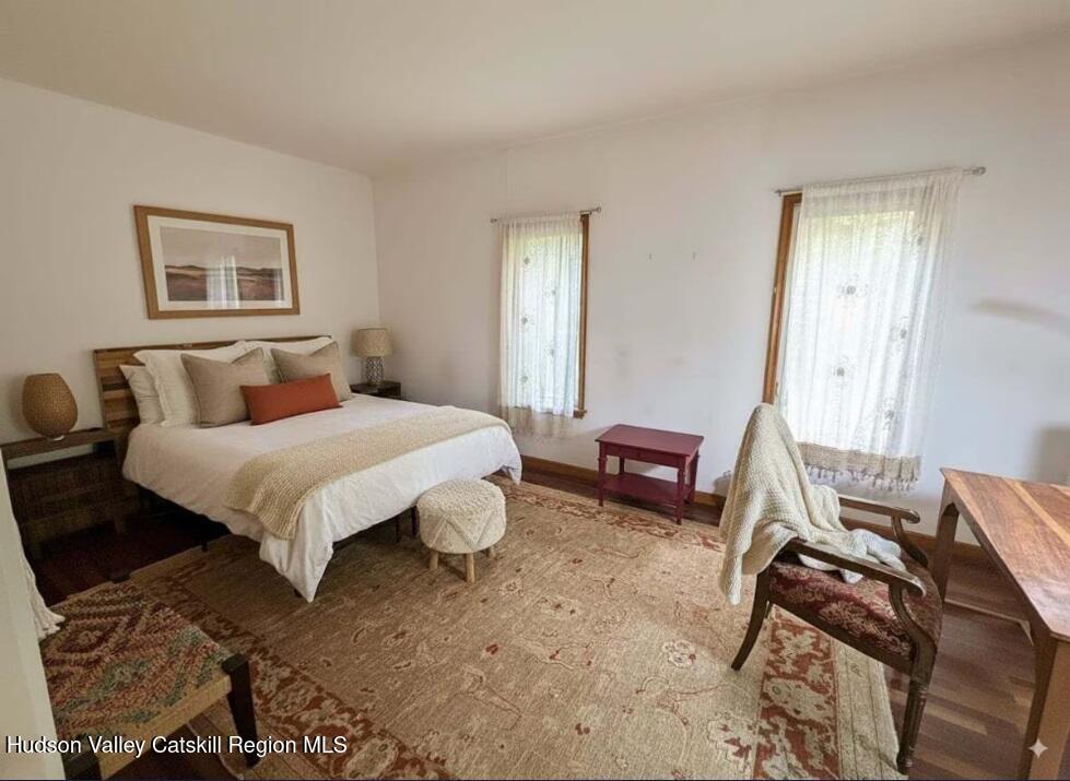 614 Salls Road New Lebanon, NY 12029 - Photo 17 of 22 a bedroom with a bed and wooden floor