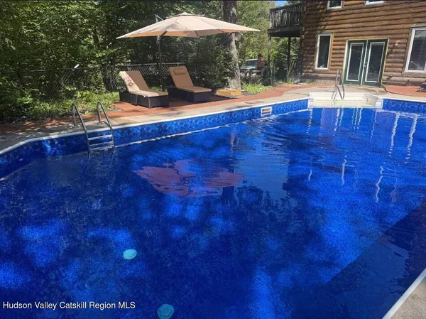 a swimming pool with outdoor seating