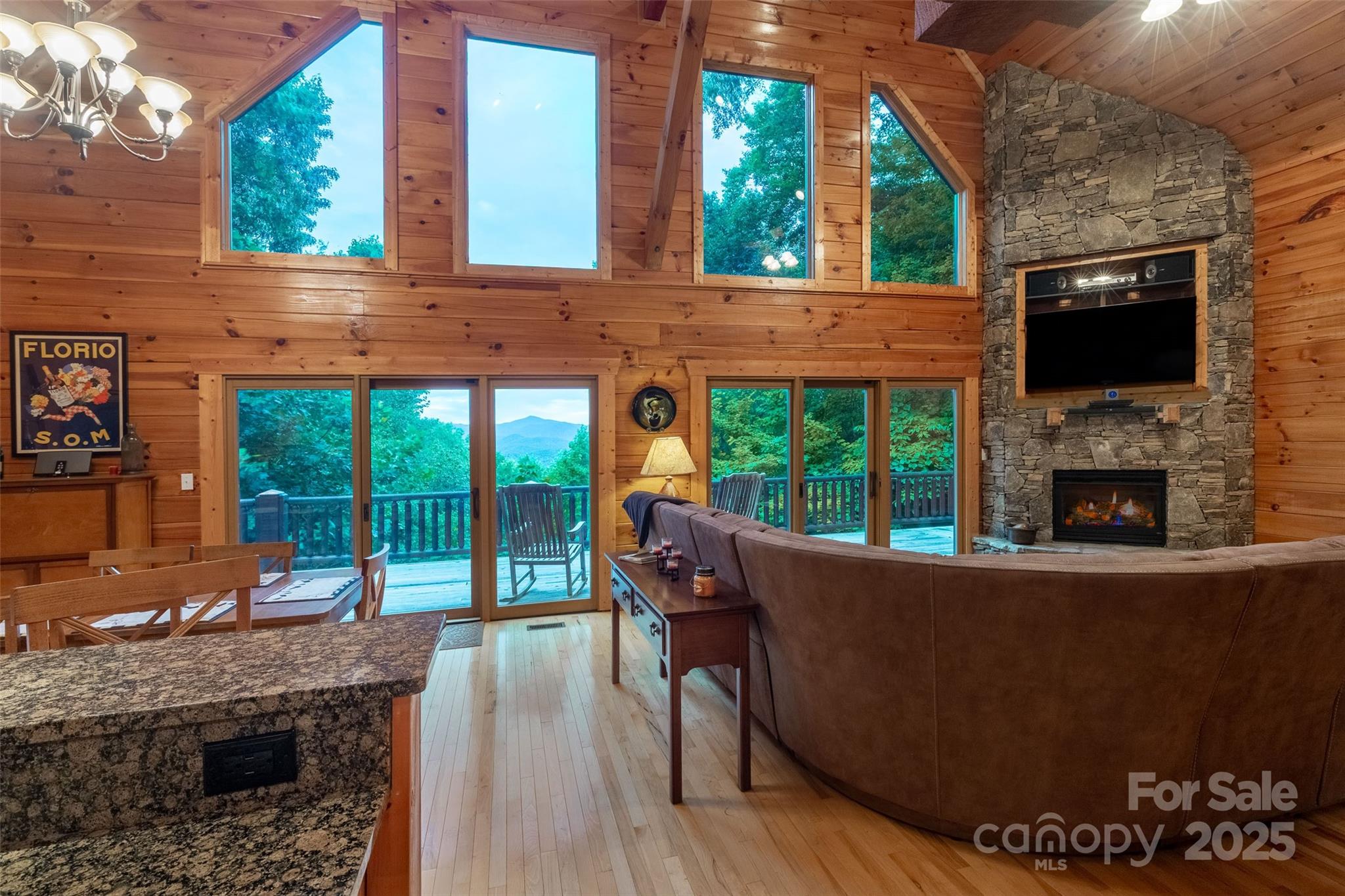 776 Still Branch Road Sylva, NC 28779 - Photo 14 of 43 a view of a patio with table and chairs a flat screen tv