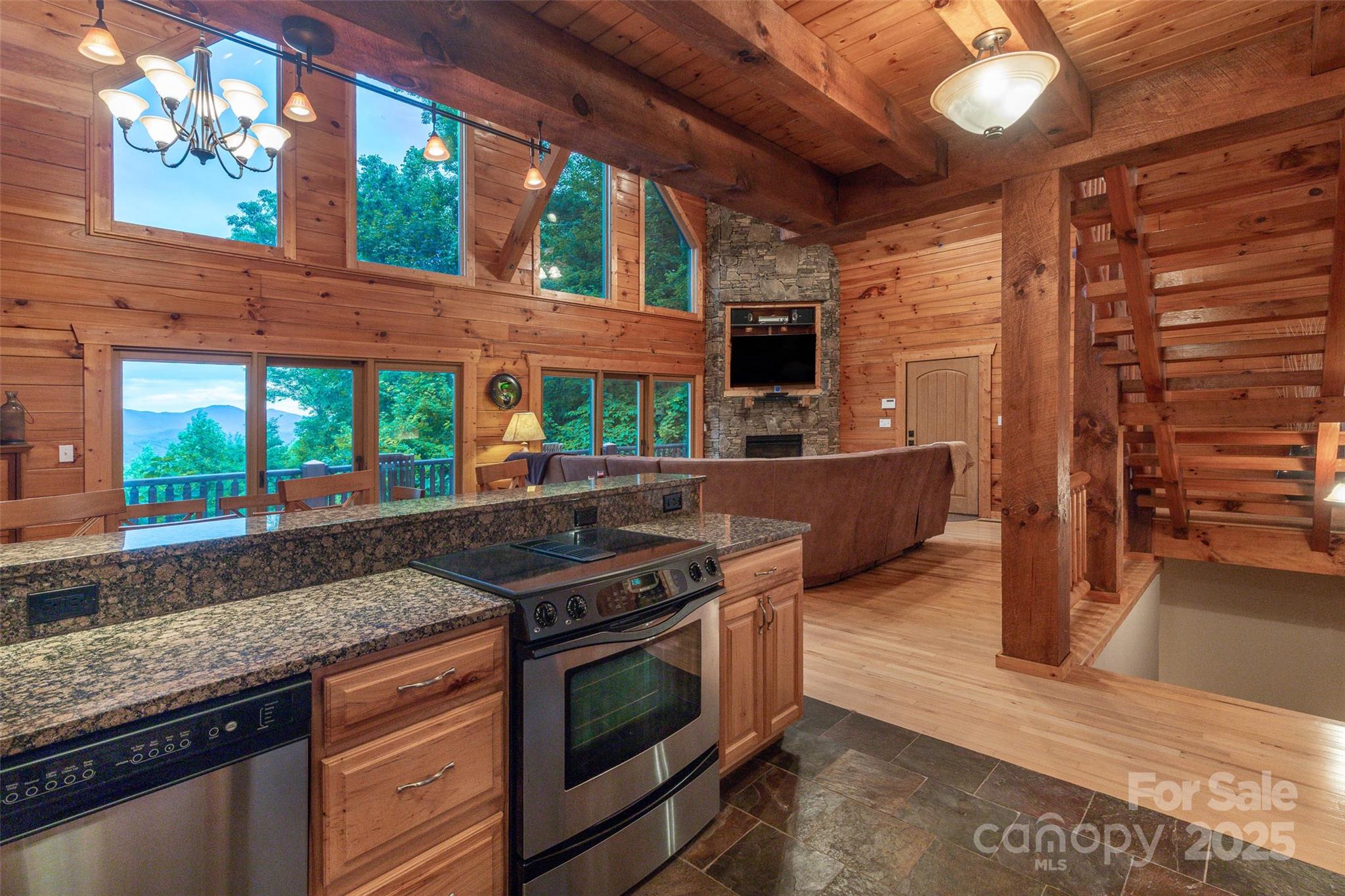 776 Still Branch Road Sylva, NC 28779 - Photo 17 of 43 a kitchen with stainless steel appliances granite countertop a stove a sink and a microwave