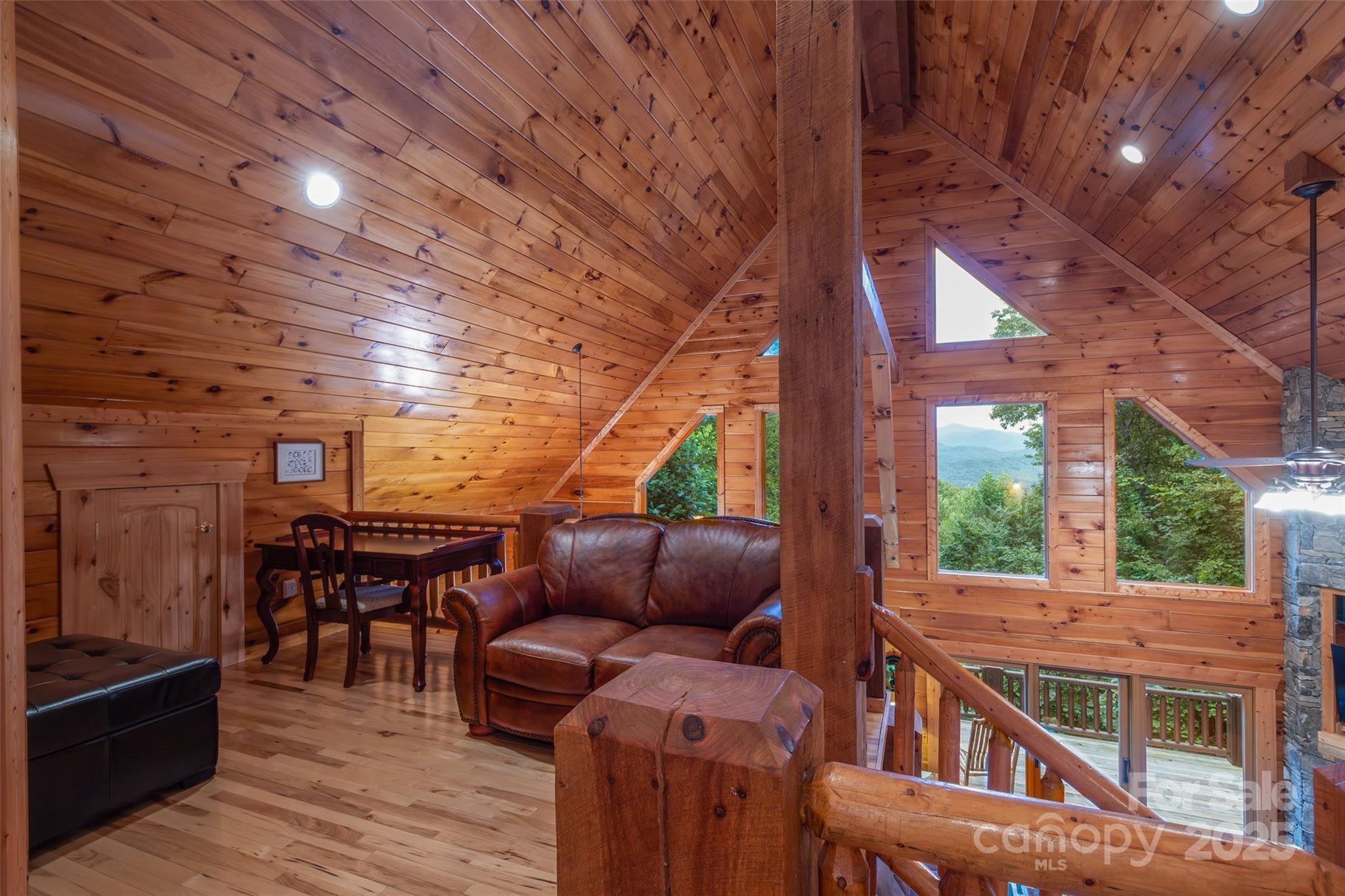 776 Still Branch Road Sylva, NC 28779 - Photo 18 of 43 a roof deck with a table and chairs