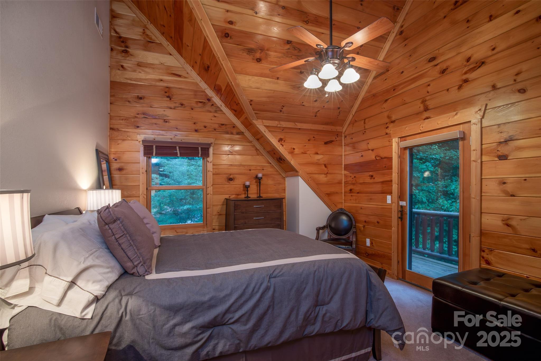 776 Still Branch Road Sylva, NC 28779 - Photo 24 of 43 a bed room with a bed and a chandelier