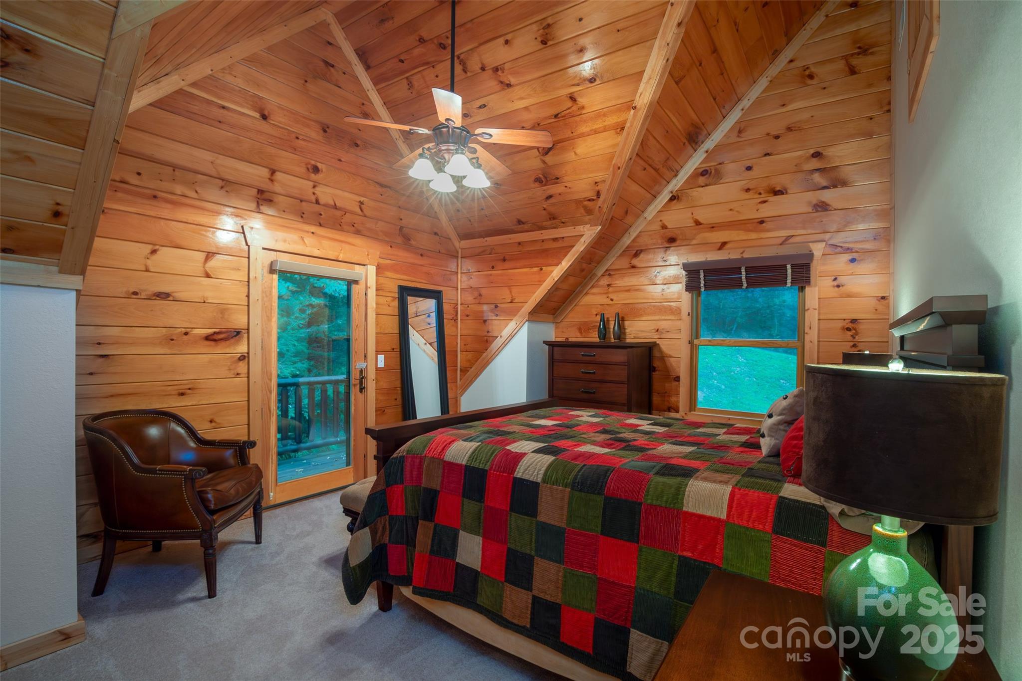 776 Still Branch Road Sylva, NC 28779 - Photo 25 of 43 a bedroom with a bed and a chair