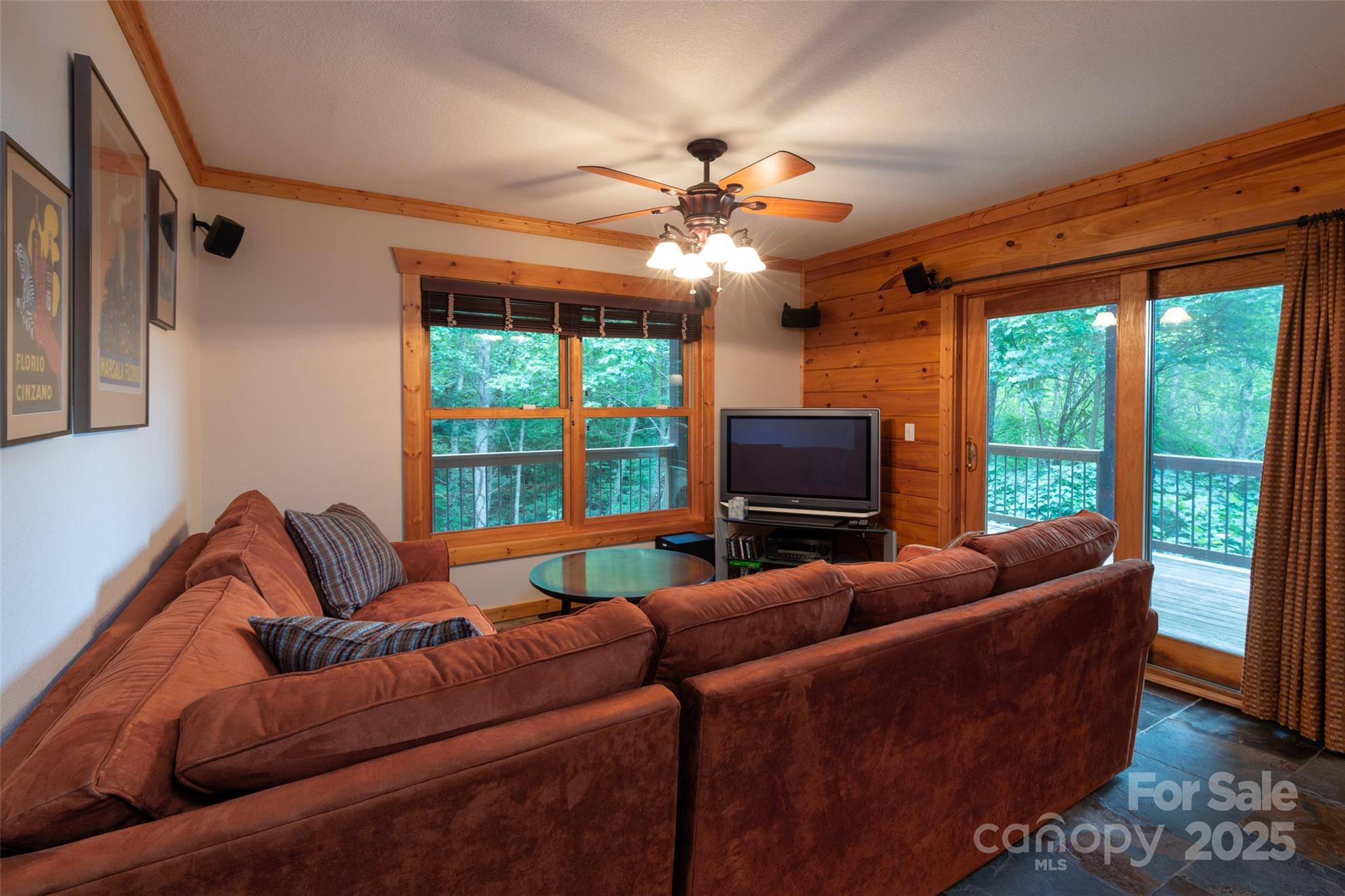 776 Still Branch Road Sylva, NC 28779 - Photo 28 of 43 a living room with furniture a ceiling fan and a flat screen tv