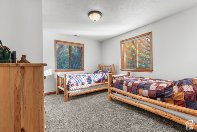 1340 Trapper Loop Garden City, UT 84028 - Photo 23 of 35 Carpeted bedroom featuring baseboards
