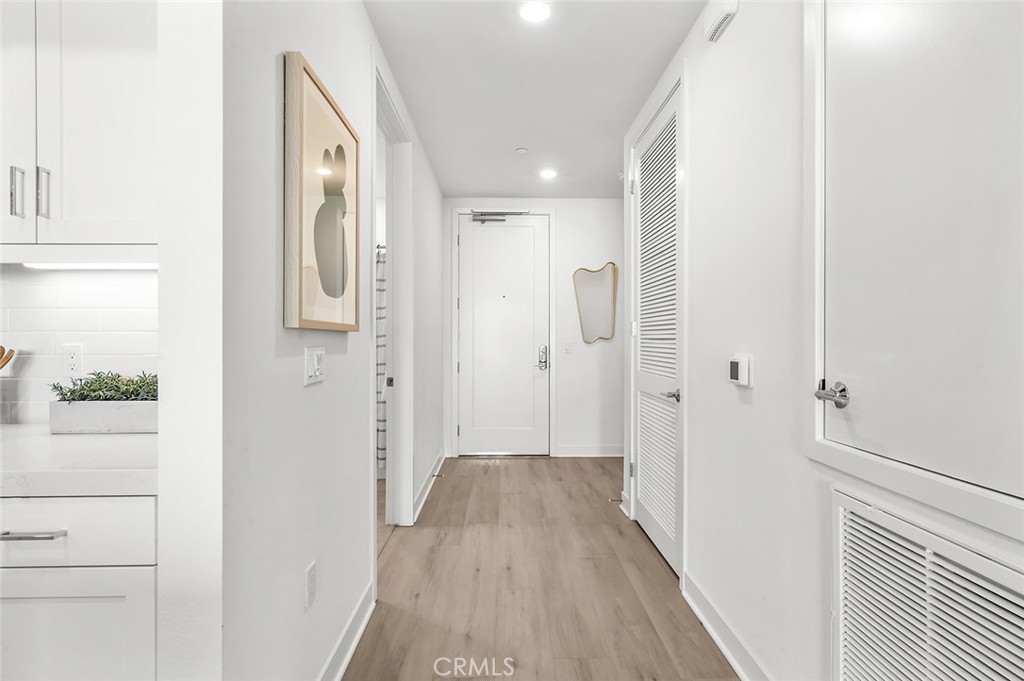3604 Rivington Irvine, CA 92612 - Photo 11 of 54 a view of a hallway with wooden floor and staircase