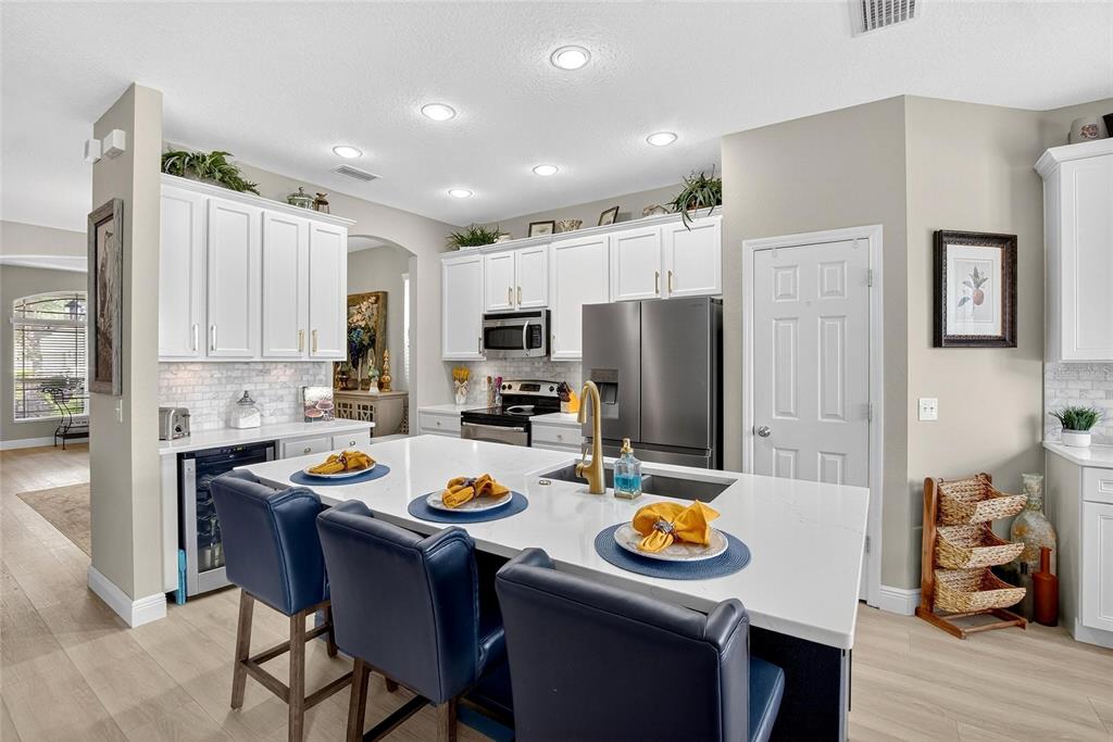 306 Hope Bay Loop Apollo Beach, FL 33572 - Photo 12 of 53 a kitchen with refrigerator and stove