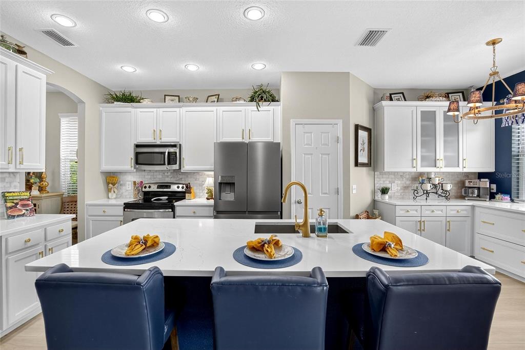 306 Hope Bay Loop Apollo Beach, FL 33572 - Photo 13 of 53 a kitchen with refrigerator and stove top oven