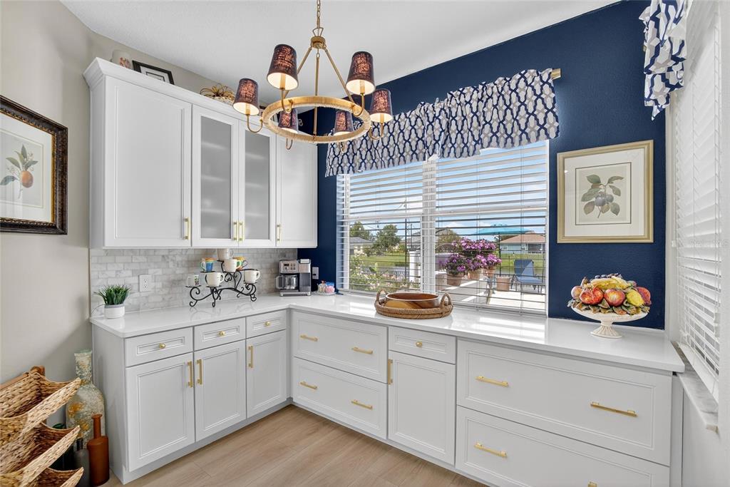 306 Hope Bay Loop Apollo Beach, FL 33572 - Photo 14 of 53 a kitchen with a sink a stove and cabinets