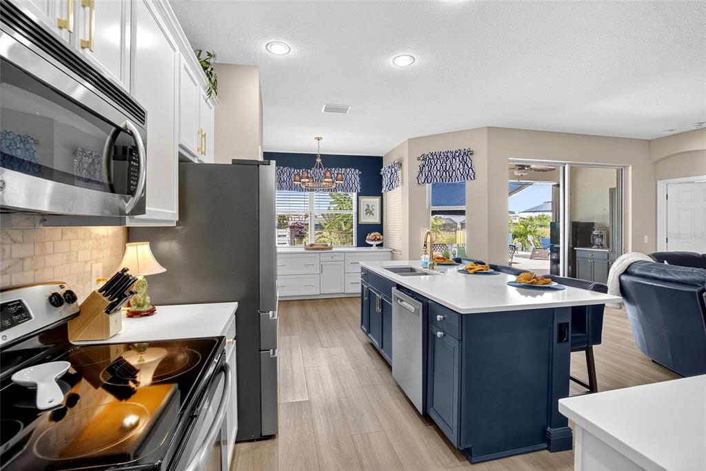 306 Hope Bay Loop Apollo Beach, FL 33572 - Photo 15 of 53 a kitchen with stainless steel appliances a sink stove and refrigerator