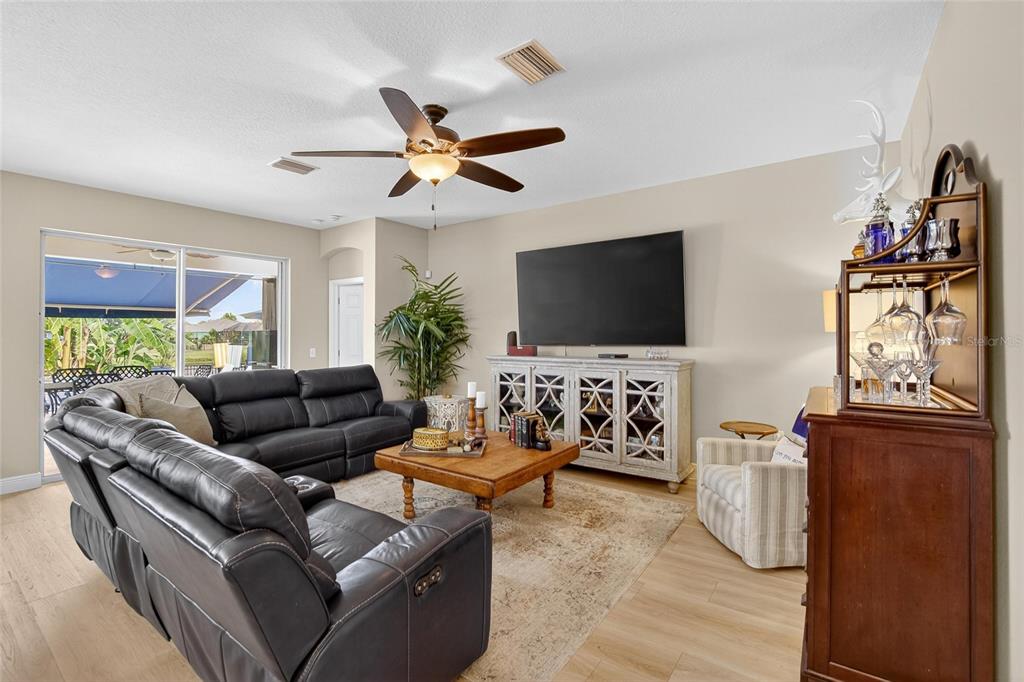 306 Hope Bay Loop Apollo Beach, FL 33572 - Photo 16 of 53 a living room with furniture and a flat screen tv
