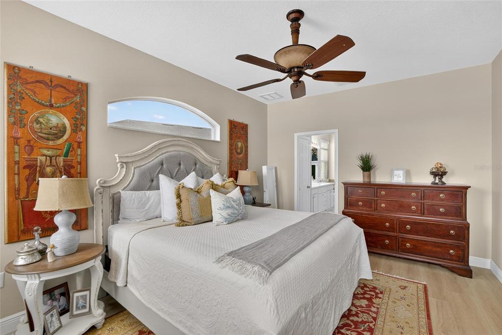 306 Hope Bay Loop Apollo Beach, FL 33572 - Photo 20 of 53 a bedroom with a bed and wooden floor