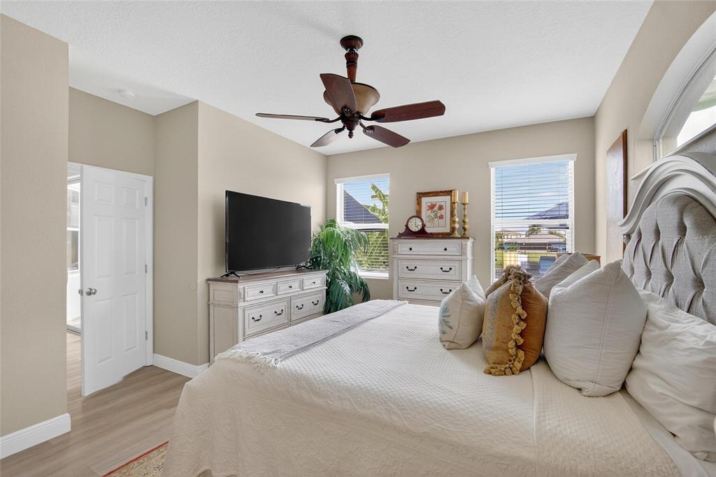 306 Hope Bay Loop Apollo Beach, FL 33572 - Photo 21 of 53 a bedroom with a bed and a flat screen tv