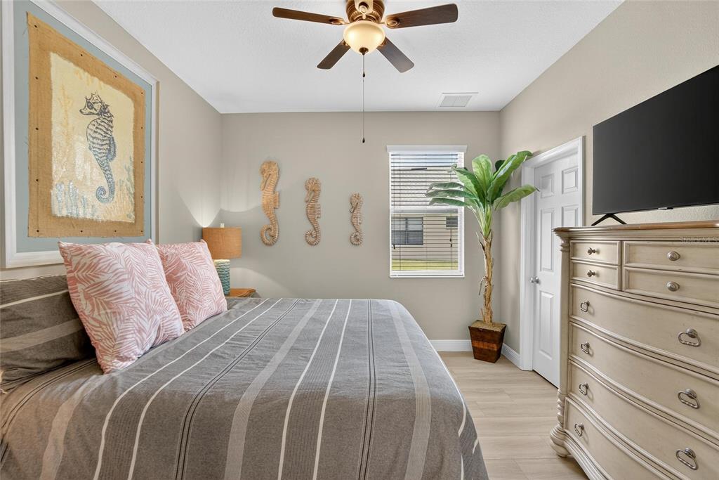 306 Hope Bay Loop Apollo Beach, FL 33572 - Photo 24 of 53 a bedroom with a large bed and a flat tv screen