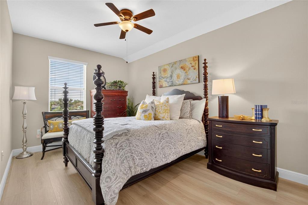 306 Hope Bay Loop Apollo Beach, FL 33572 - Photo 35 of 53 a bedroom with a bed and a chandelier